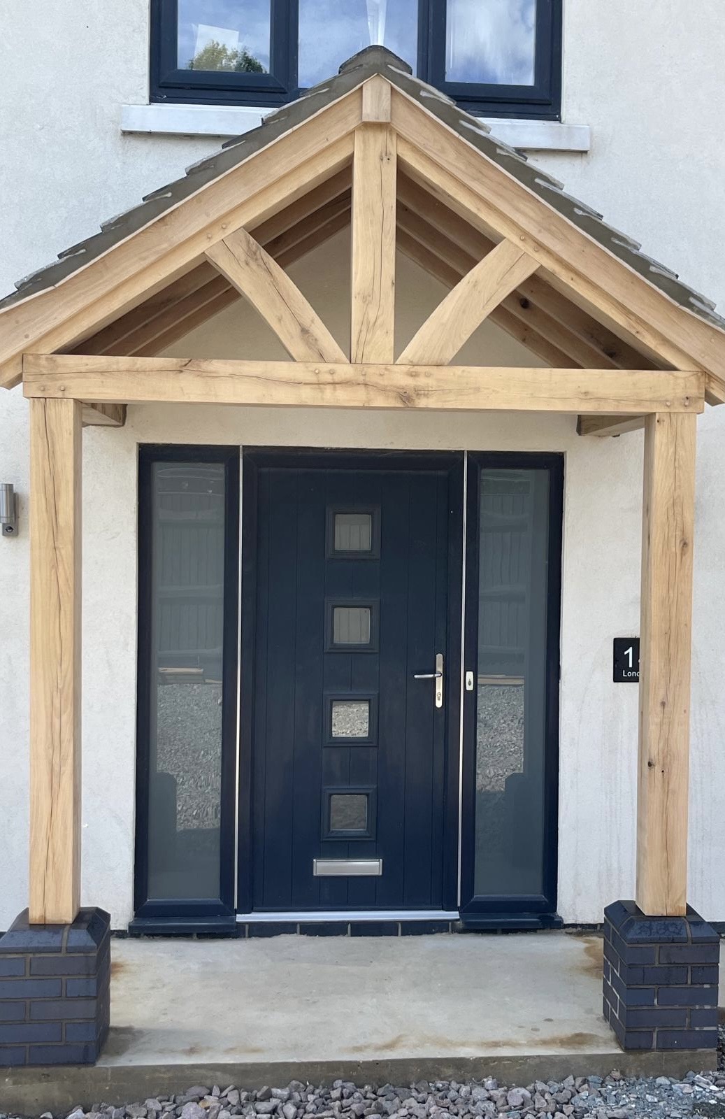 Completed oak porch installed over modern front entrance by family-run joinery business in Cambridgeshire. 