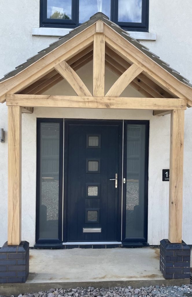 Completed oak porch installed over modern front entrance in Chatteris by family-run joinery business in Cambridgeshire.
