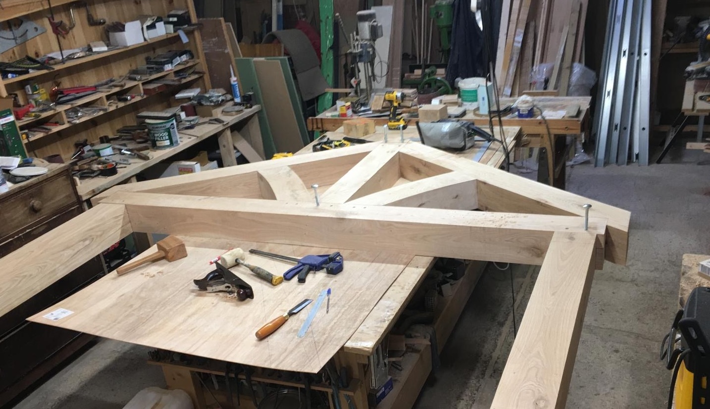 Oak porch frame under construction in joinery workshop using traditional oak joinery techniques.