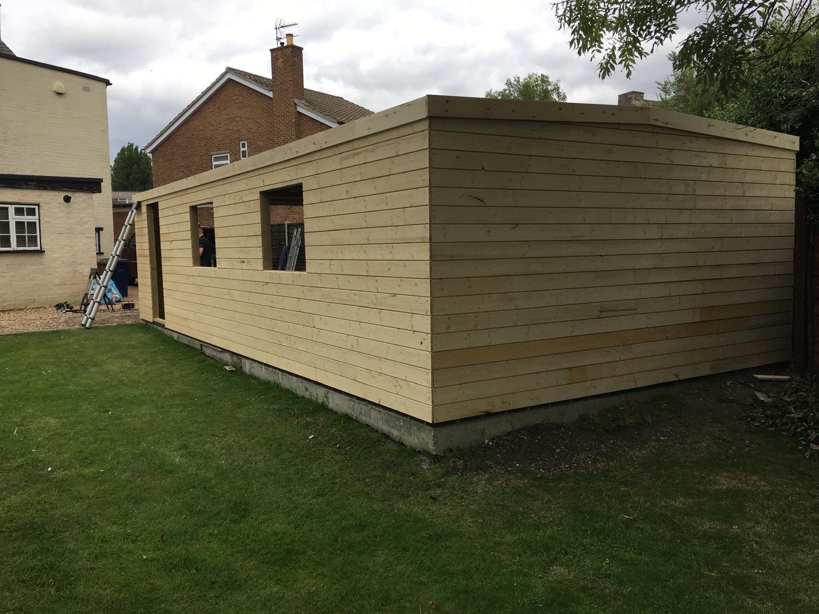 Completed timber garage with horizontal shiplap cladding installed in March Cambridgeshire.