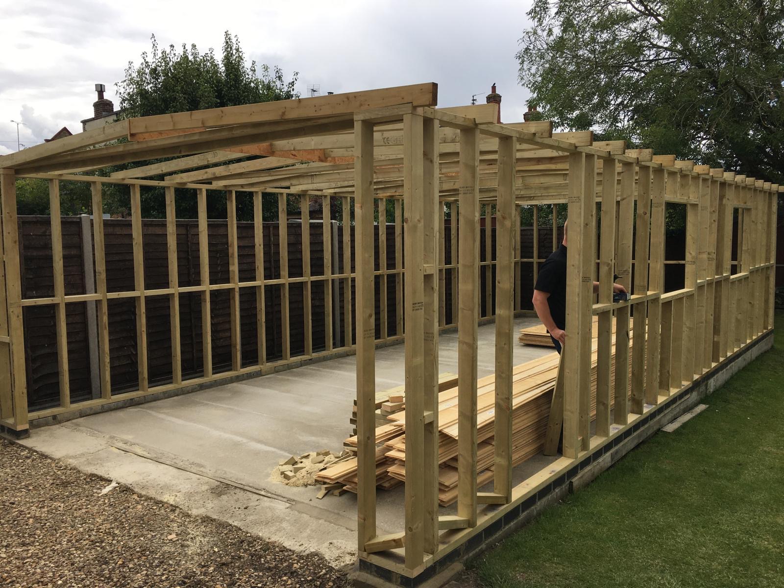 Timber garage frame being built on site in March Cambridgeshire with structural studwork and base in place.