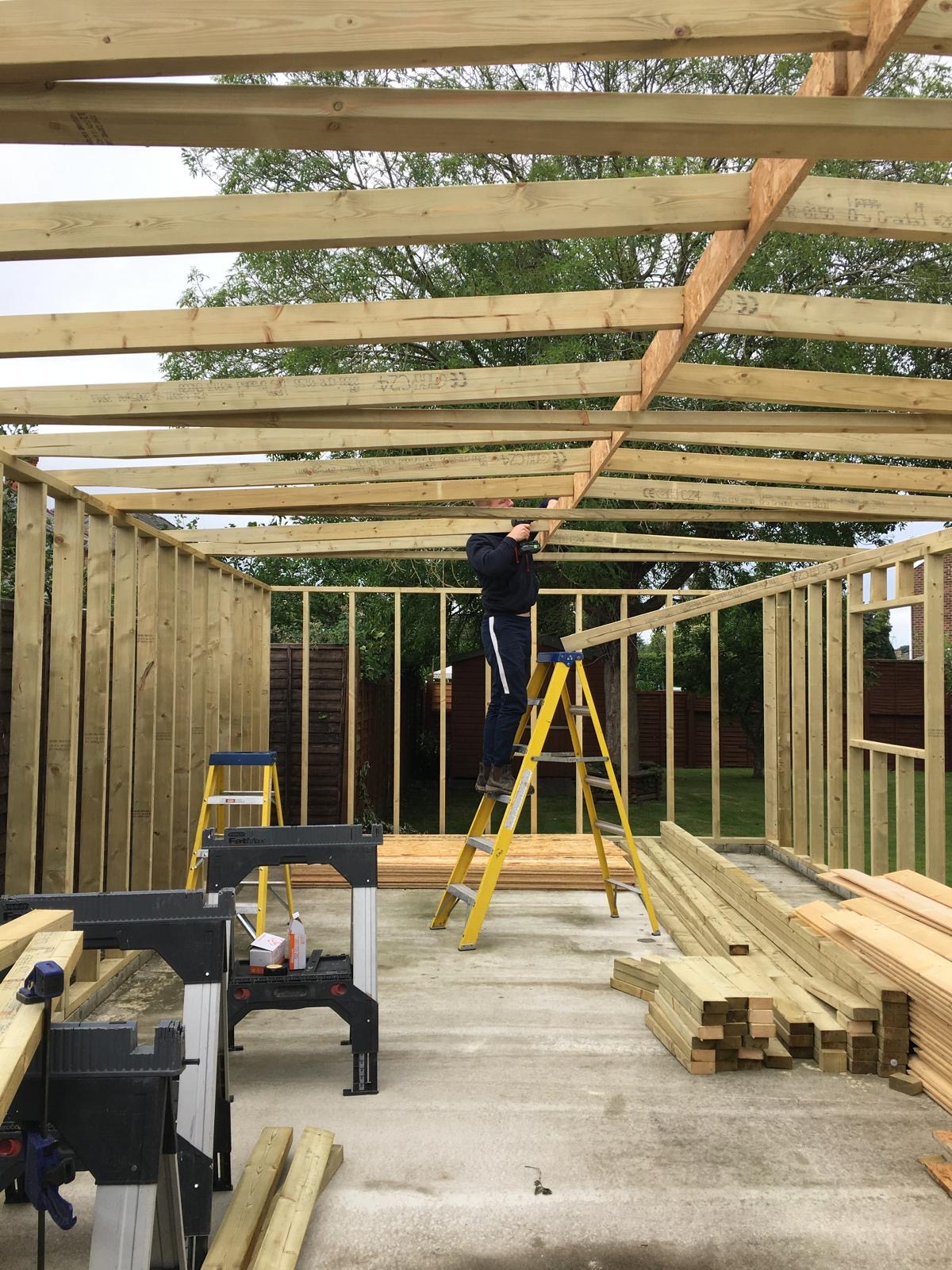 Timber frame under construction for a bespoke four-car garage, built by experienced carpenters in Cambridgeshire.