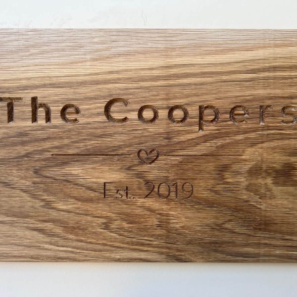 Personalised oak wall plaque engraved with family name The Coopers, Est. 2019.