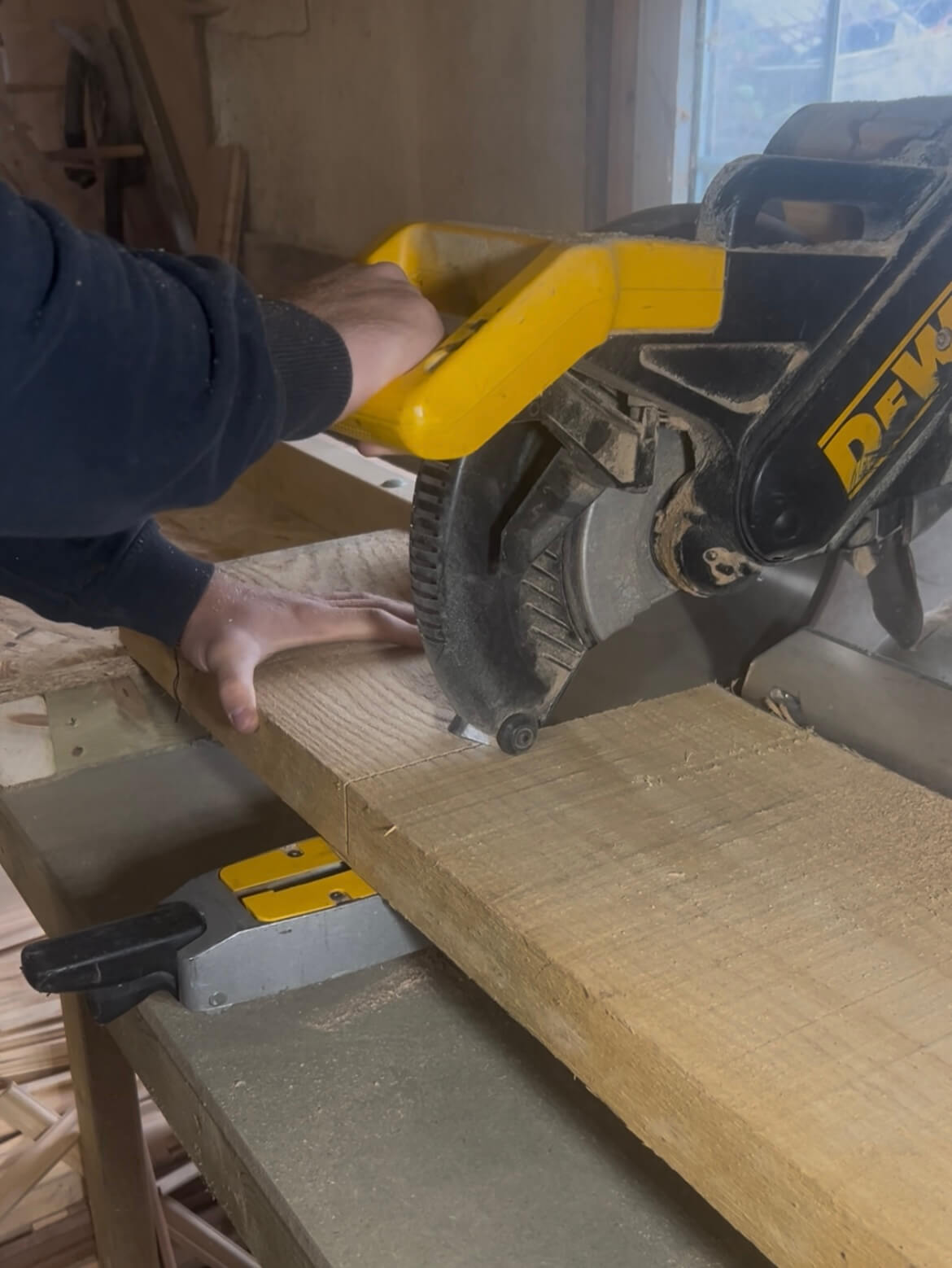 Cutting FSC-certified solid oak using a mitre saw for handcrafted personalised wooden gifts.