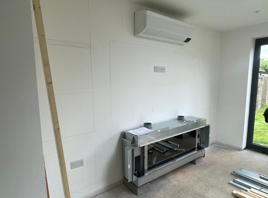 Media wall build in progress with fireplace unit and framework before installation Cambridgeshire.