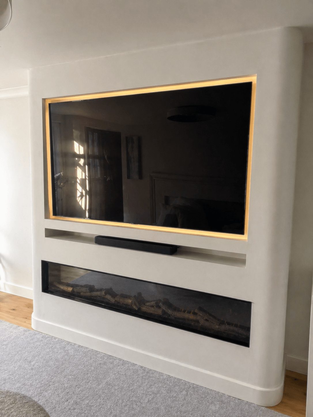 Bespoke media wall with fireplace and recessed TV with LED lighting Cambridgeshire.