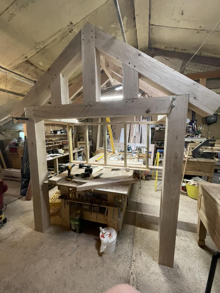Traditional oak porch frame construction inside joinery workshop in Cambridgeshire.