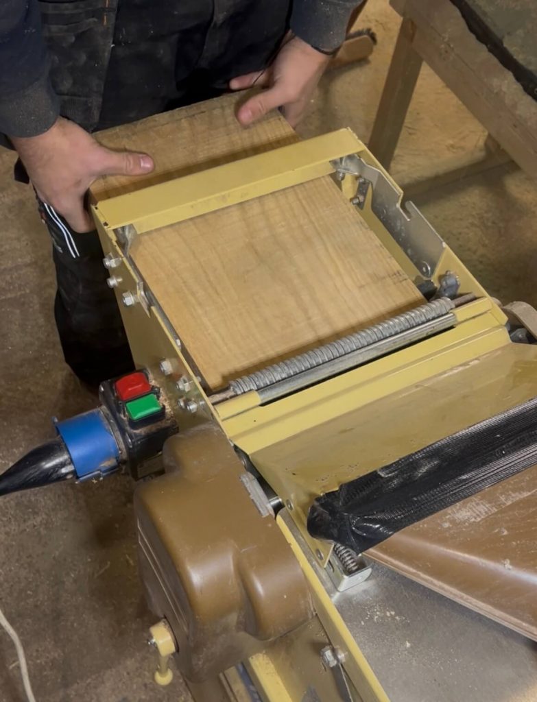 Preparing a raw piece of FSC-certified oak using a planer before crafting a personalised chopping board.