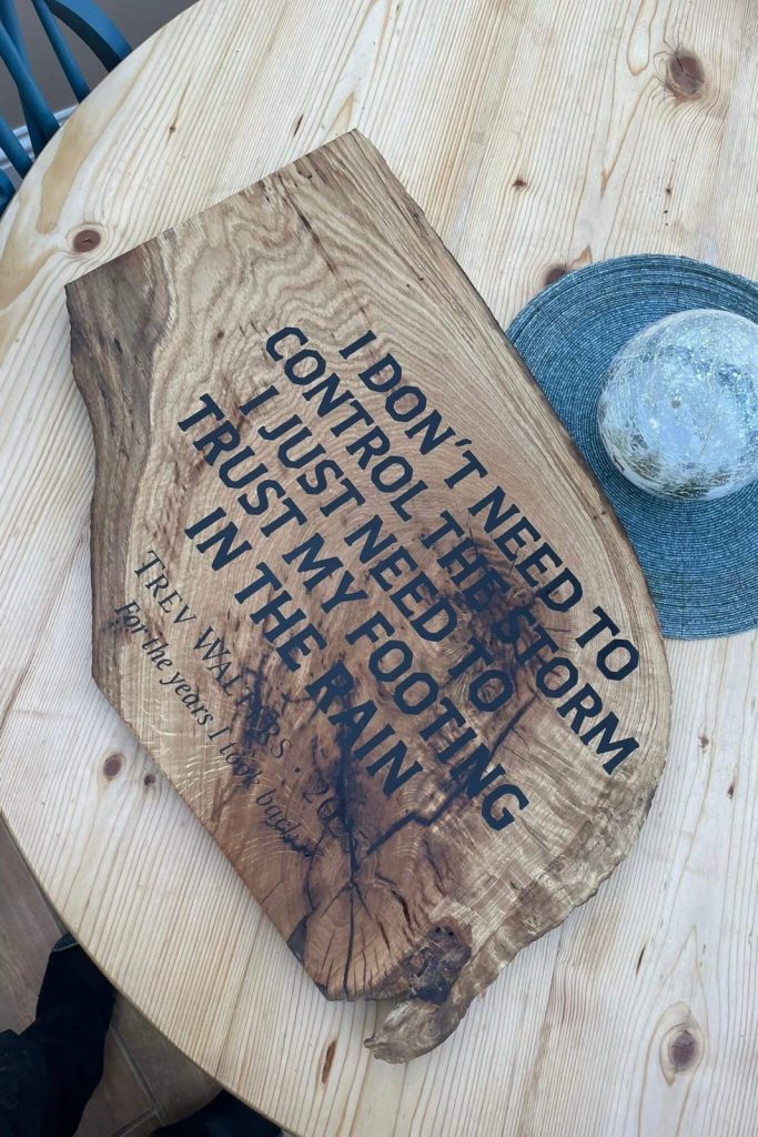 Finished bespoke live-edge oak plaque with deeply engraved personalised quote, restored and resin-filled for stability, created by KMP Carpentry & Joinery as part of our CNC engraving services.