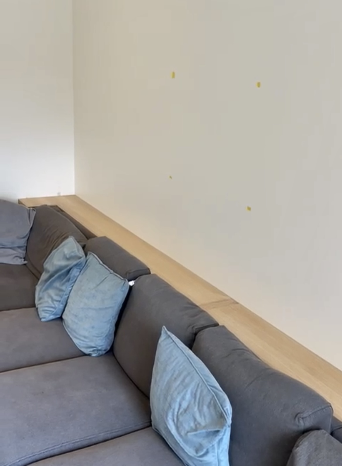 Bespoke oak console table fitted behind sofa in living room, handcrafted as part of a custom carpentry project in Cambridgeshire.