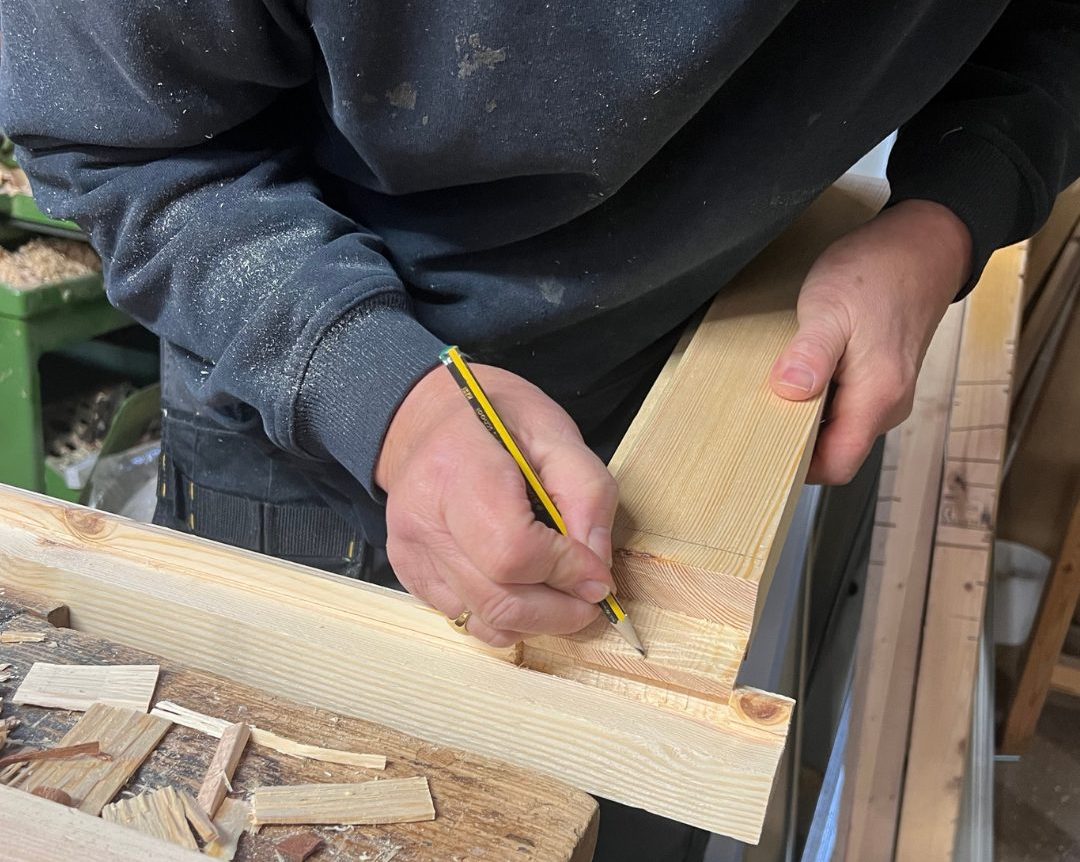Commercial joinery preparation in workshop with precision timber marking and assembly.