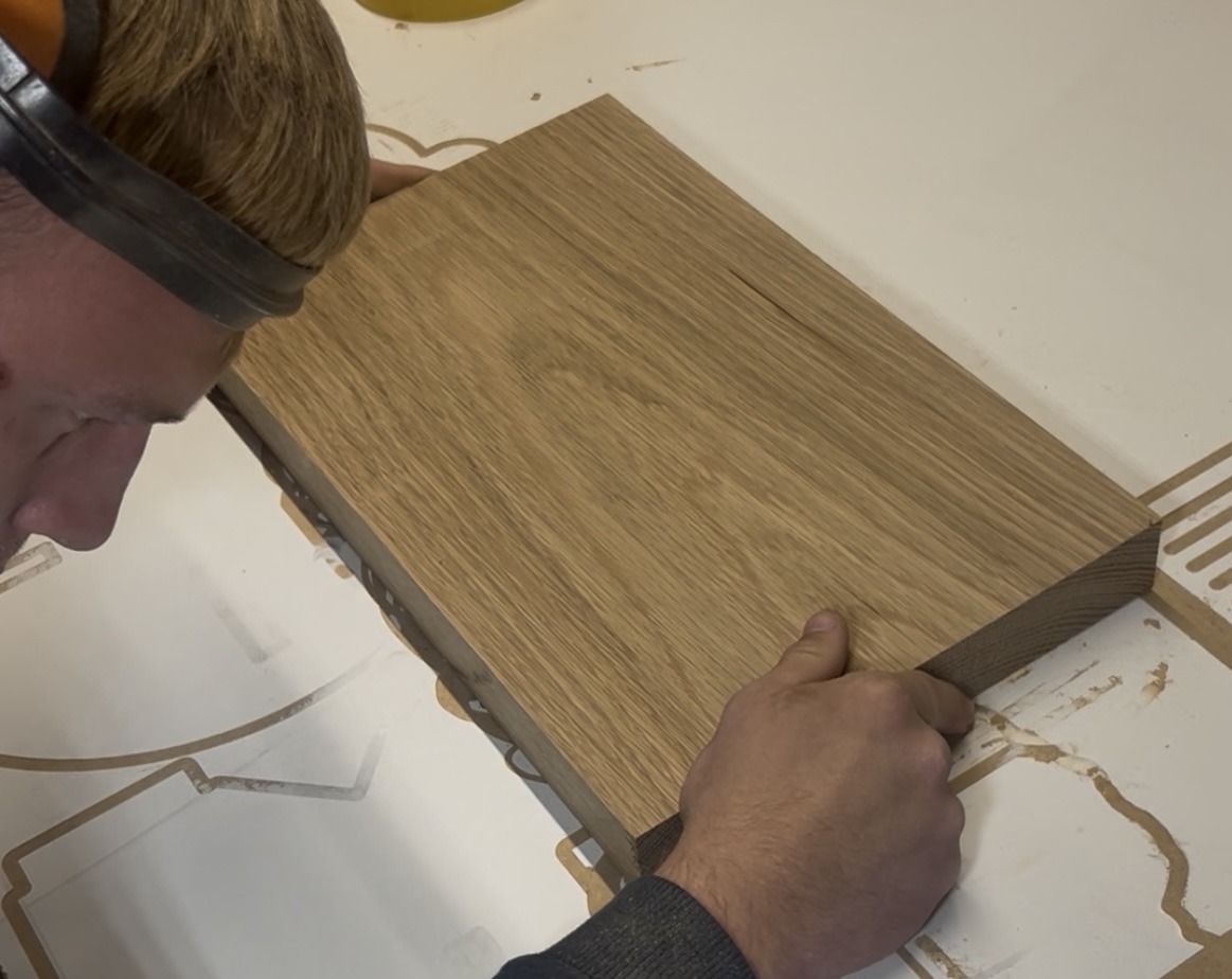 Hardwood timber aligned on CNC bed before machining, workshop-based CNC production in Cambridgeshire.