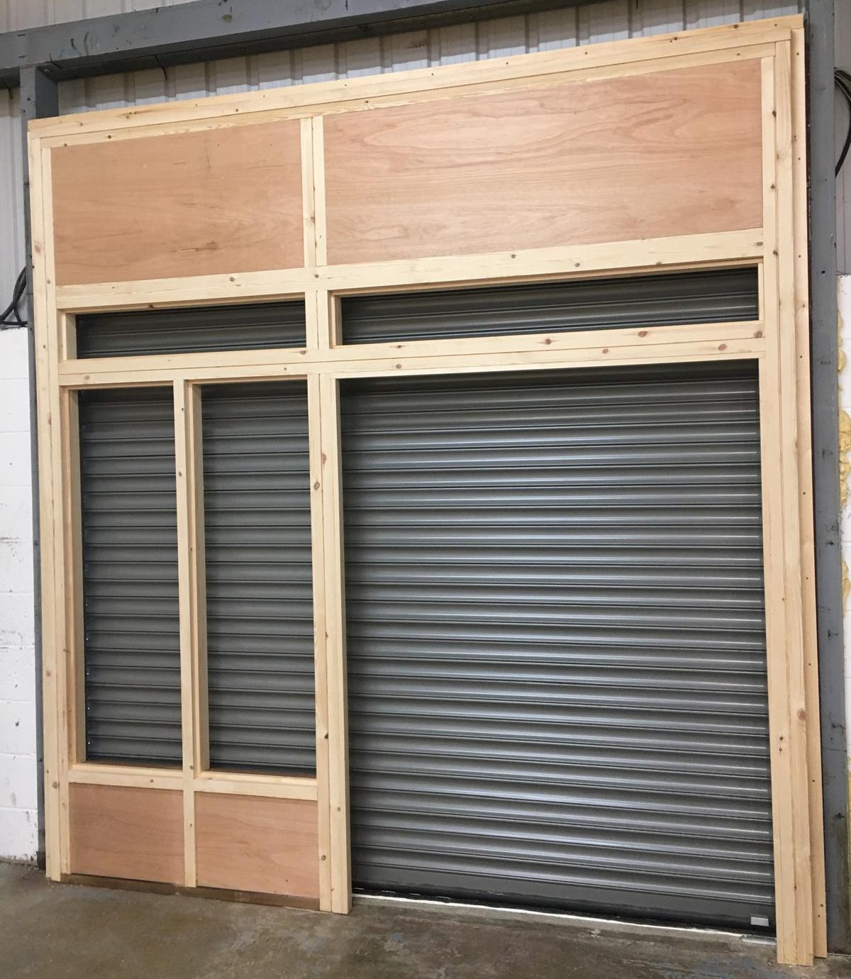 Commercial shop front joinery installation with timber framing and entrance doors.