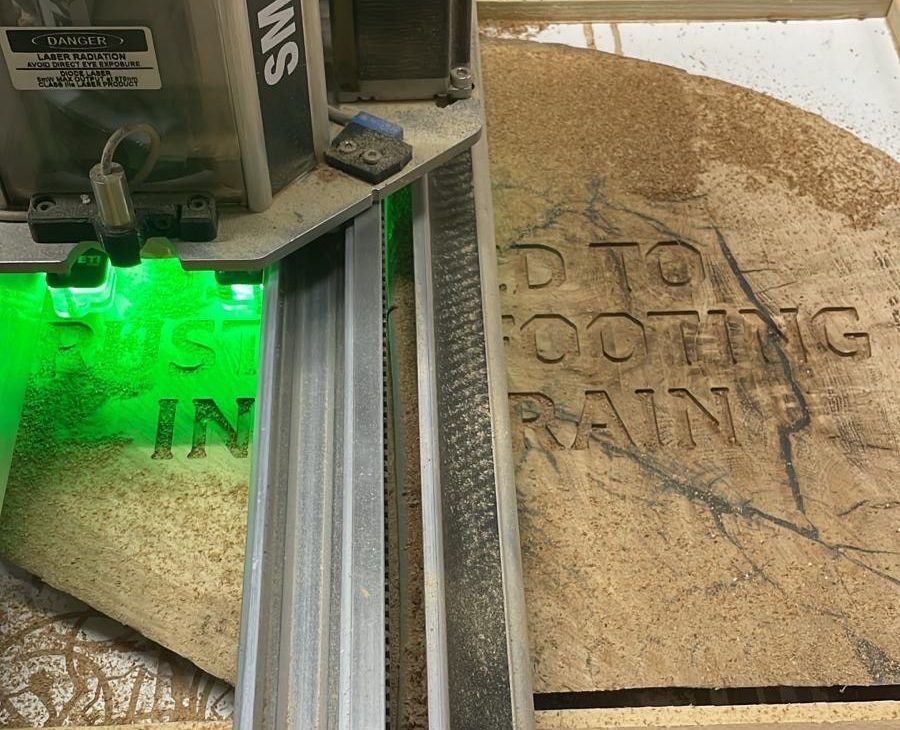 CNC router engraving timber panel in Cambridgeshire joinery workshop.