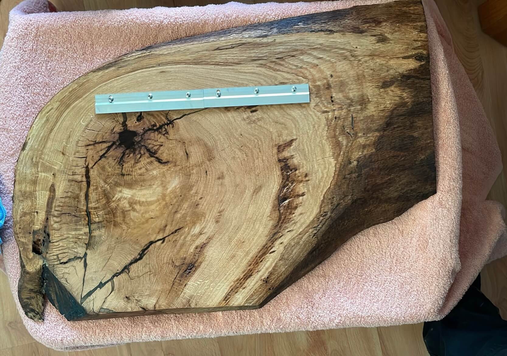 French cleat hanging system fitted to the back of a custom engraved live edge oak plaque.