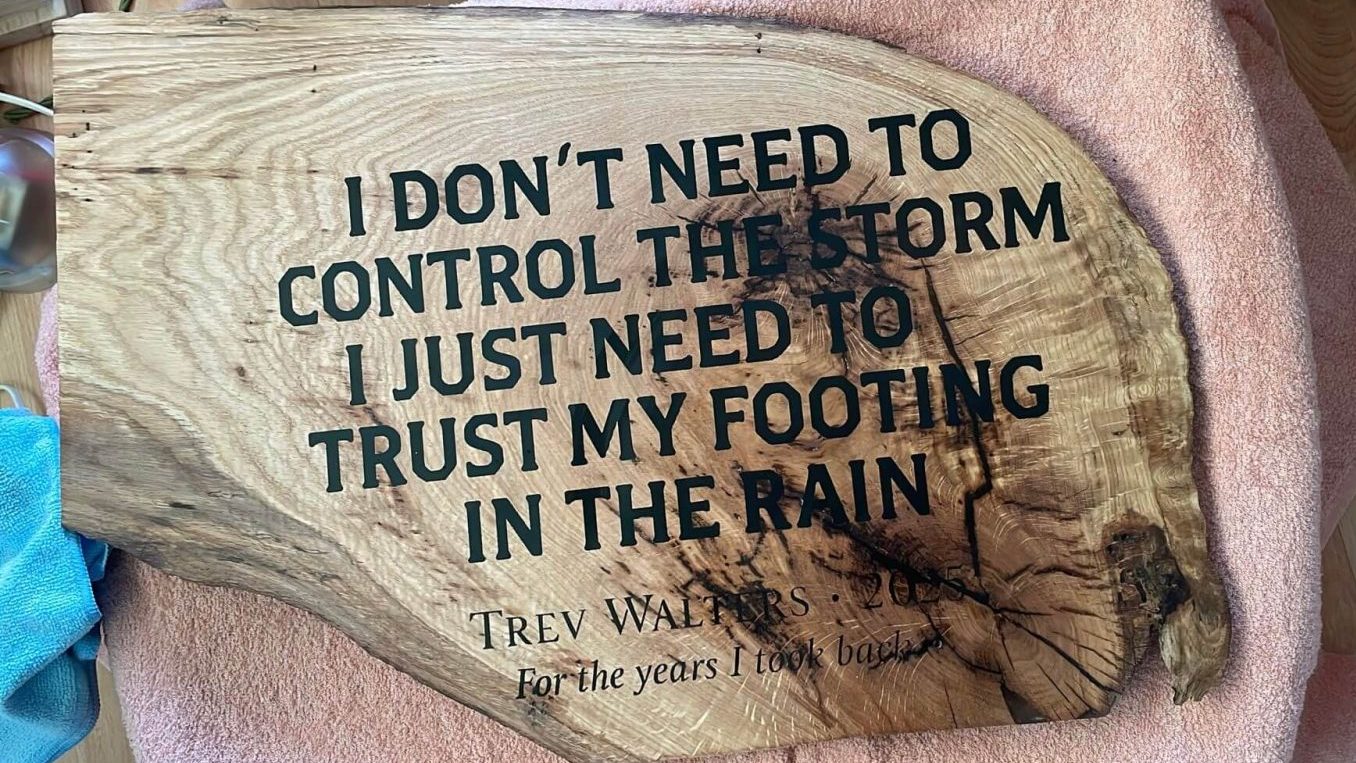 Custom engraved oak memorial plaque with resin filled lettering, natural grain preserved and live edge detail.