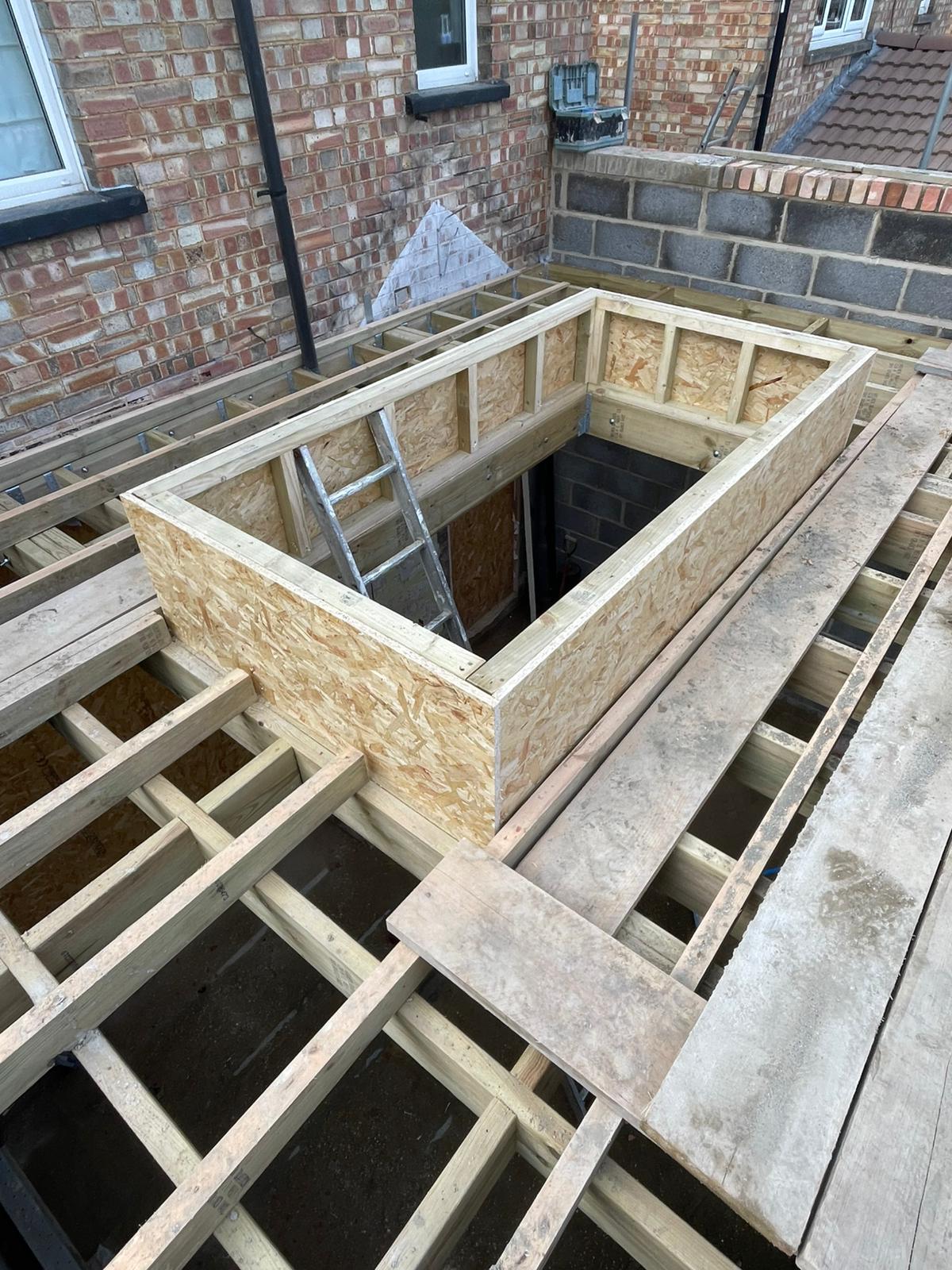 Timber roof framework and ply boarding during rear extension build in Cambridgeshire.