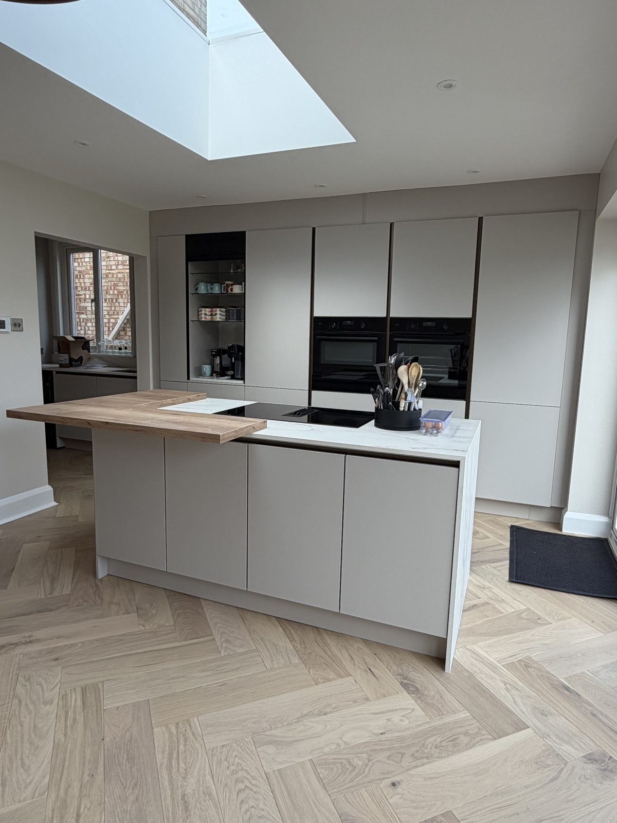 Completed kitchen installation with herringbone wood flooring in rear extension, March Cambridgeshire.