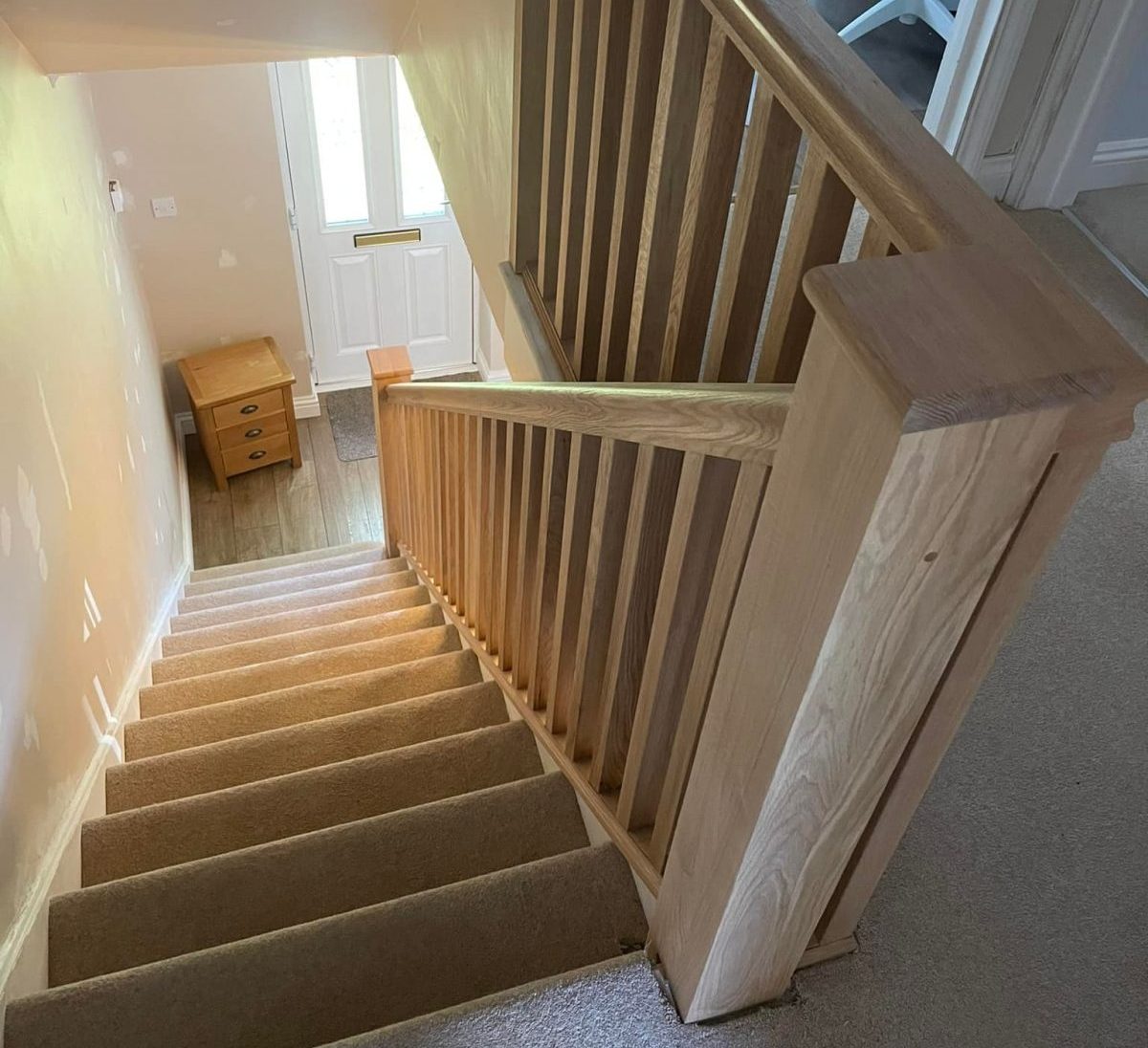Solid oak staircase renovation with new handrails and balustrade, crafted and installed in Cambridgeshire.