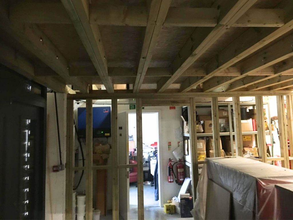 Timber joists and mezzanine floor construction forming additional upper-level storage space in a commercial carpentry project in Cambridgeshire.