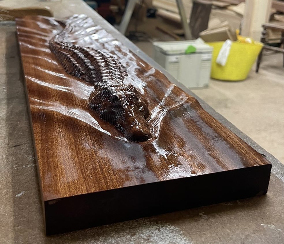 Detailed CNC carved hardwood panel demonstrating precision machining capability.