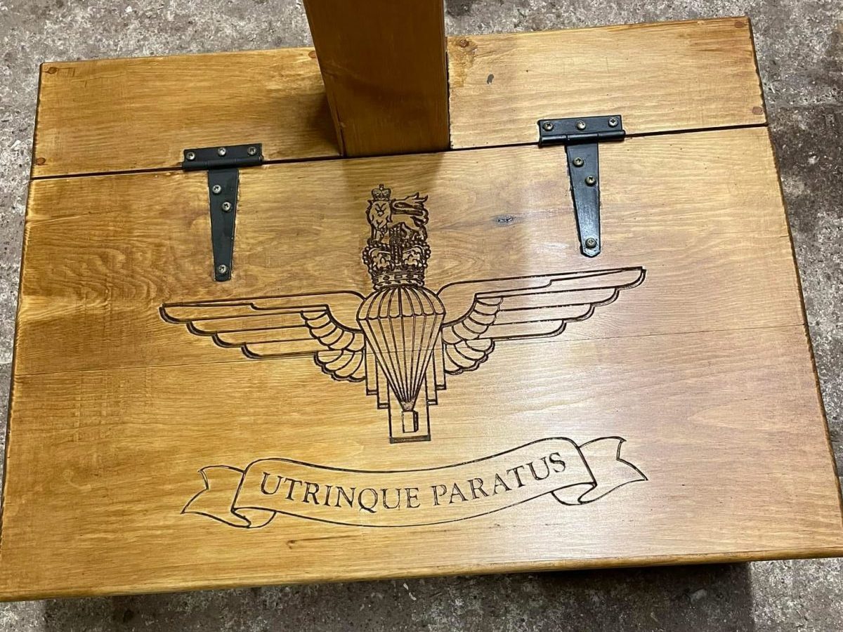 Bespoke CNC engraving for a custom armour stand panel, combining precision machining with traditional timber work.