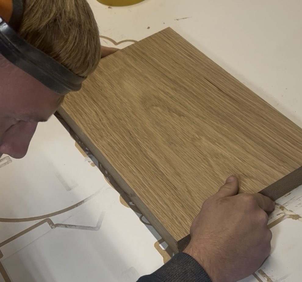 Joiner assembling CNC machined timber components for fitted joinery project.