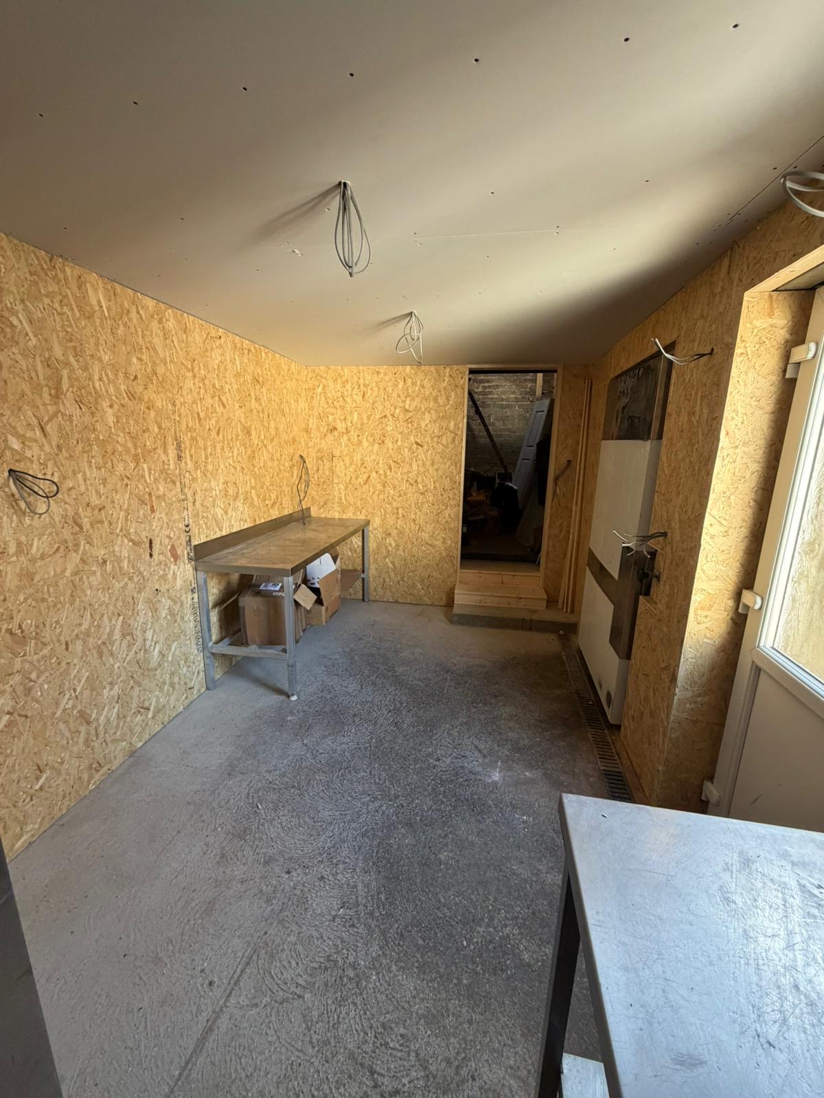 OSB wall boarding installed during commercial internal fit out for butchers prep room.