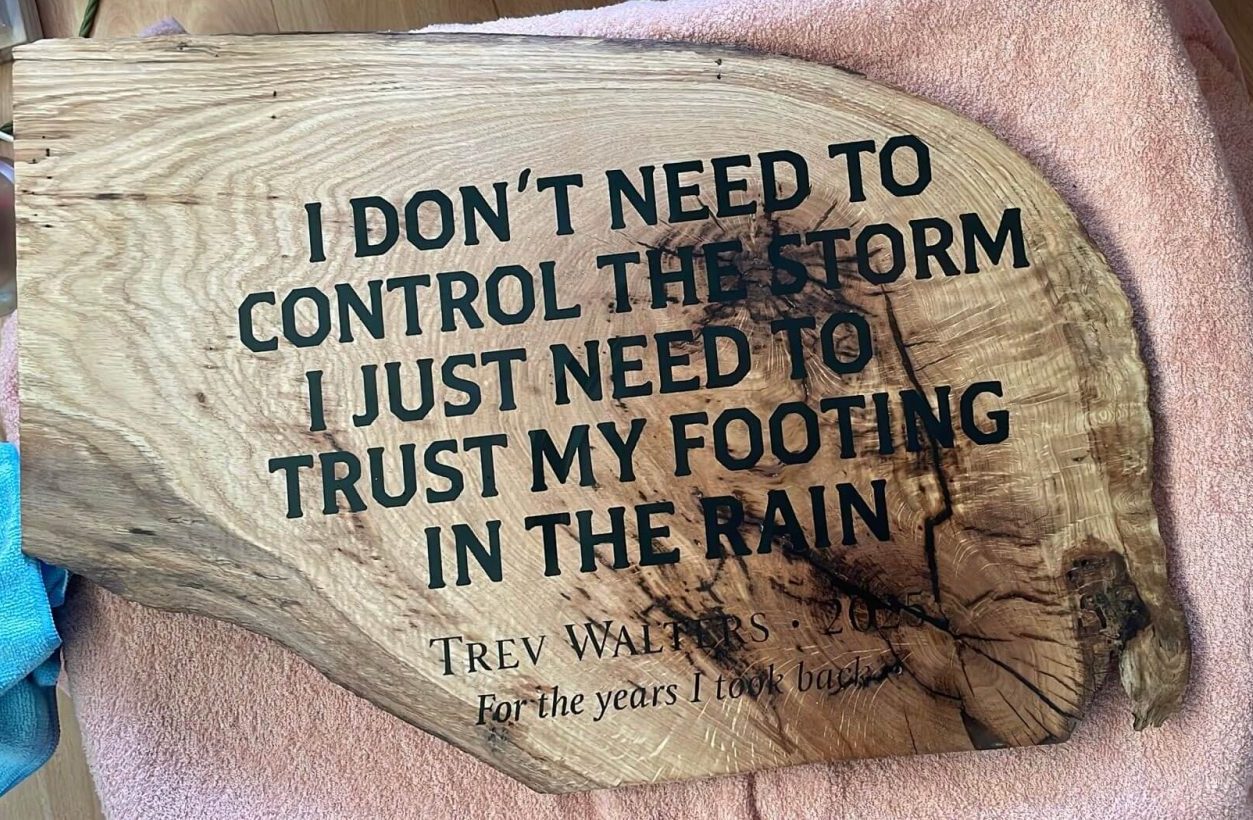 CNC engraved text on live edge oak slab supplied by client, custom woodworking project UK.