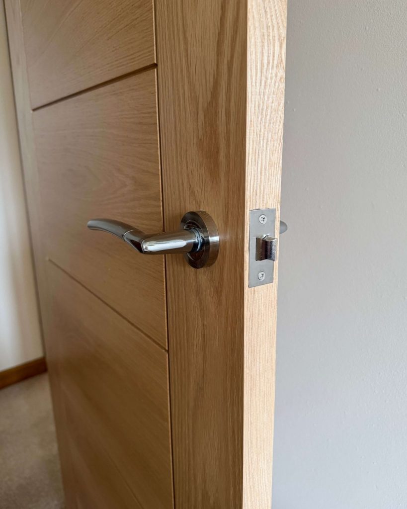 Close-up of oak internal door with modern handle.