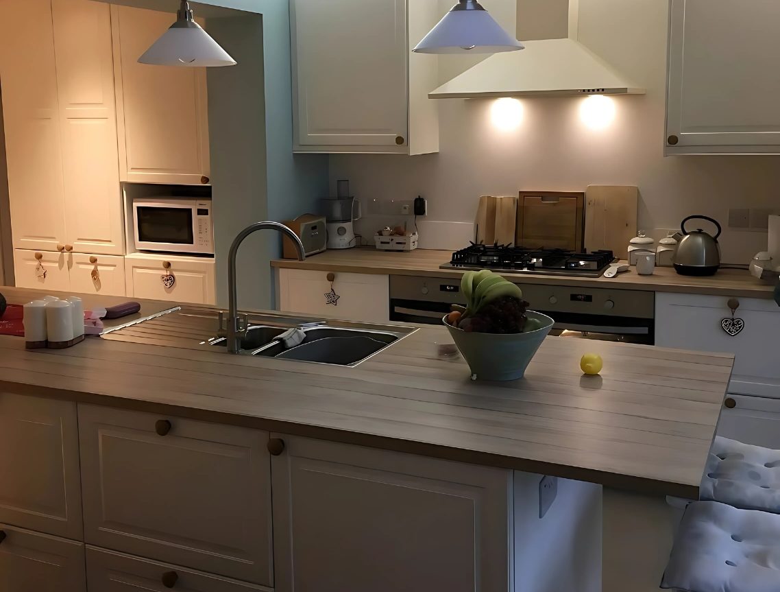 Kitchen joinery with island and fitted cabinetry in a Cambridgeshire home.
