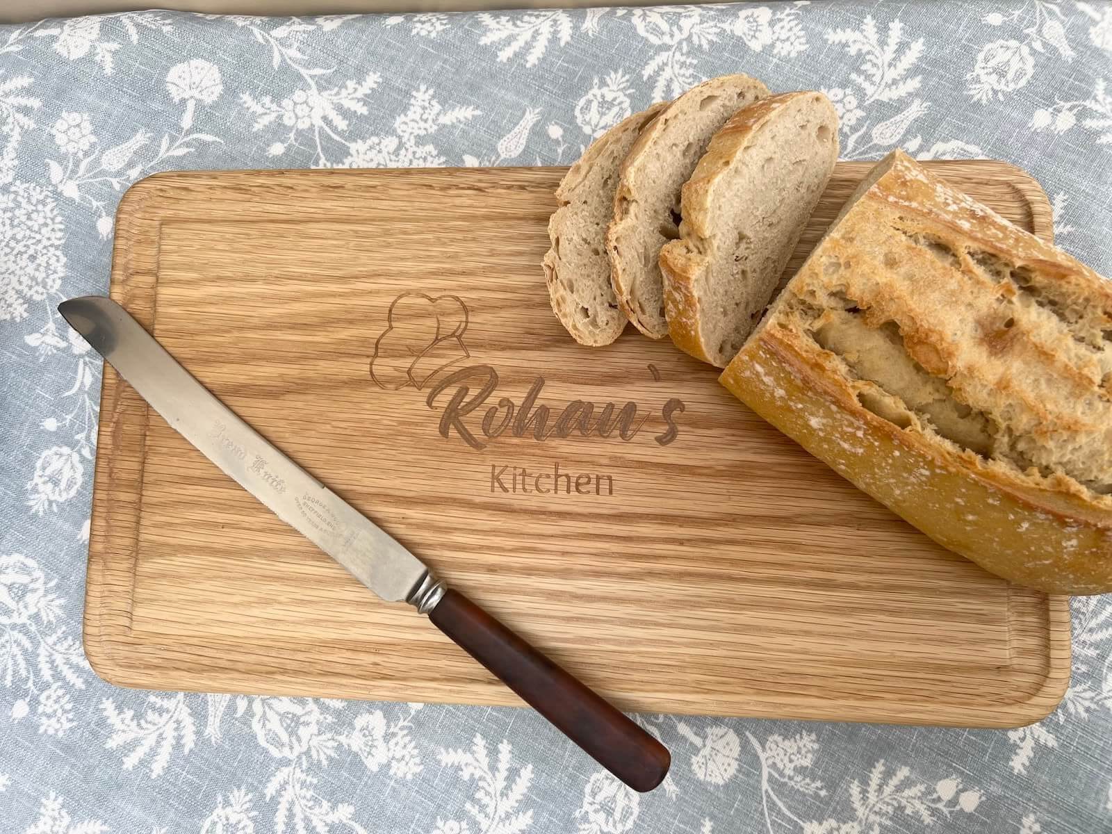 Personalised solid oak chopping board with engraved design, made to order UK.