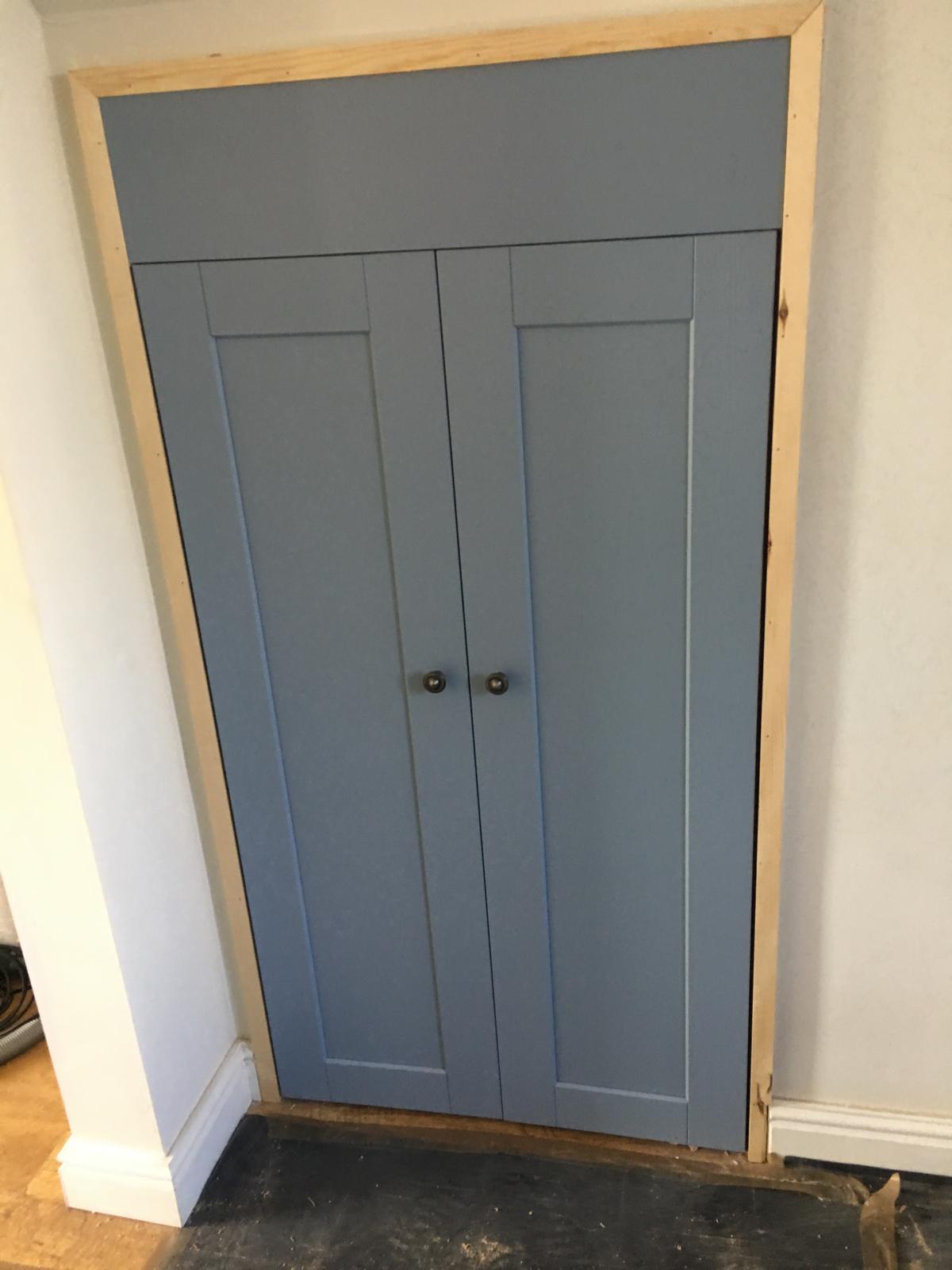 Fitted alcove cupboard with drawers and doors in kitchen space.