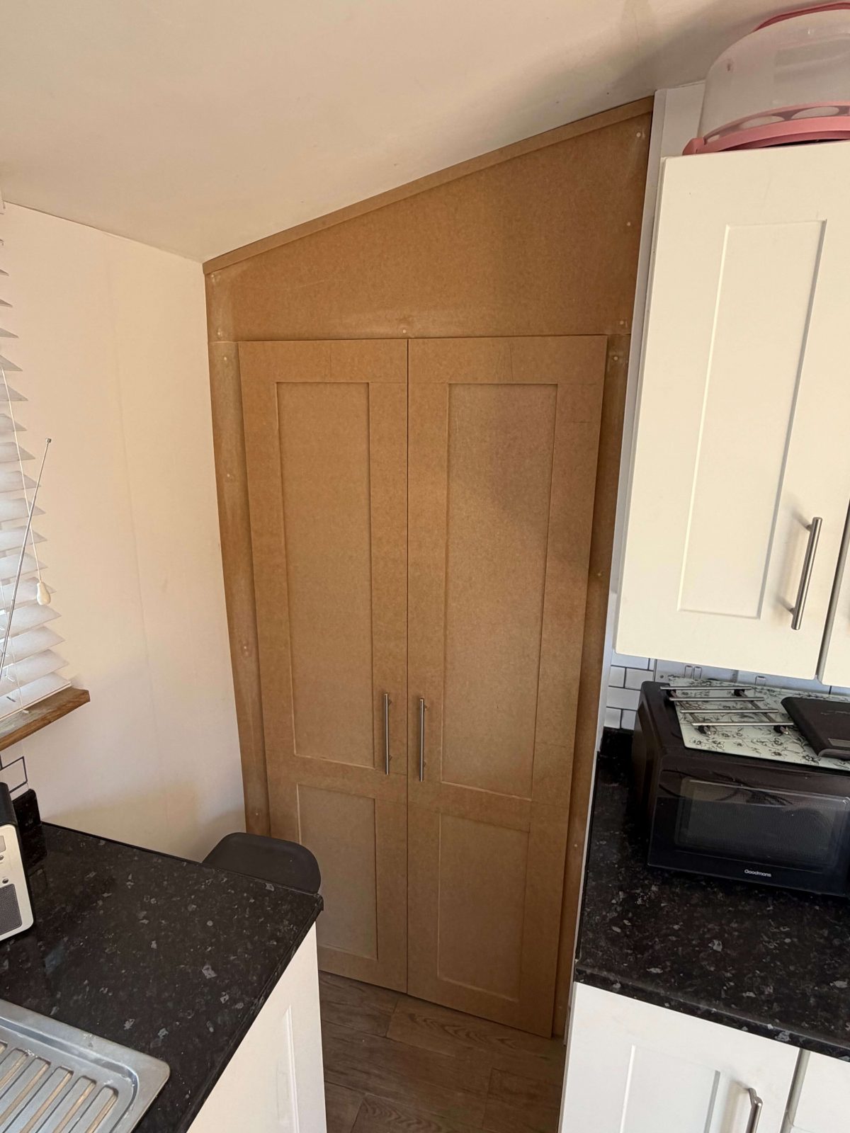 Bespoke fitted alcove cupboard in kitchen with concealed boiler housing Cambridgeshire.