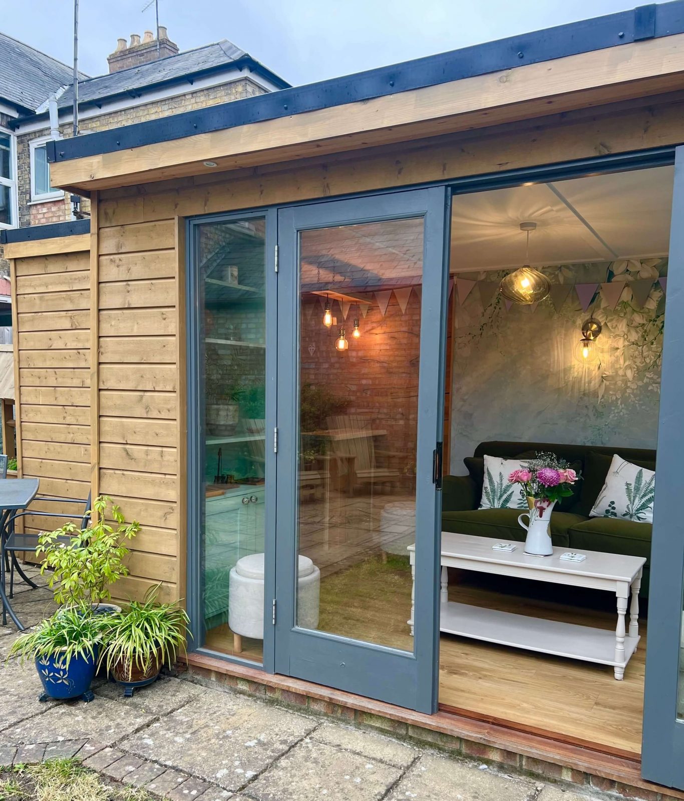 Bespoke garden room with bar area and patio doors in Cambridgeshire by KMP Carpentry & Joinery.