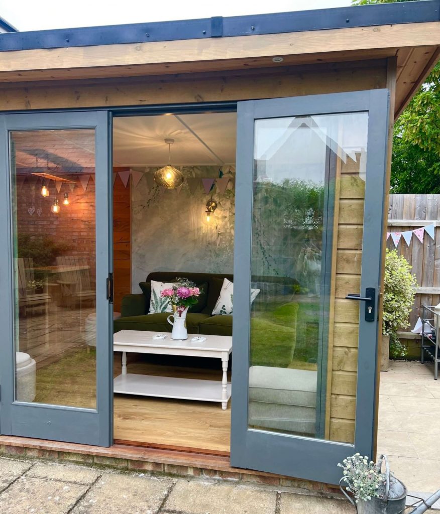 Completed timber frame garden room in Cambridgeshire with glazed doors and timber cladding.