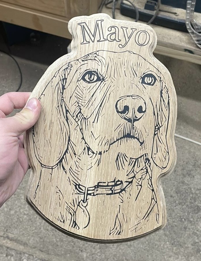 CNC engraved wooden pet plaque with dog portrait and resin detail in oak.