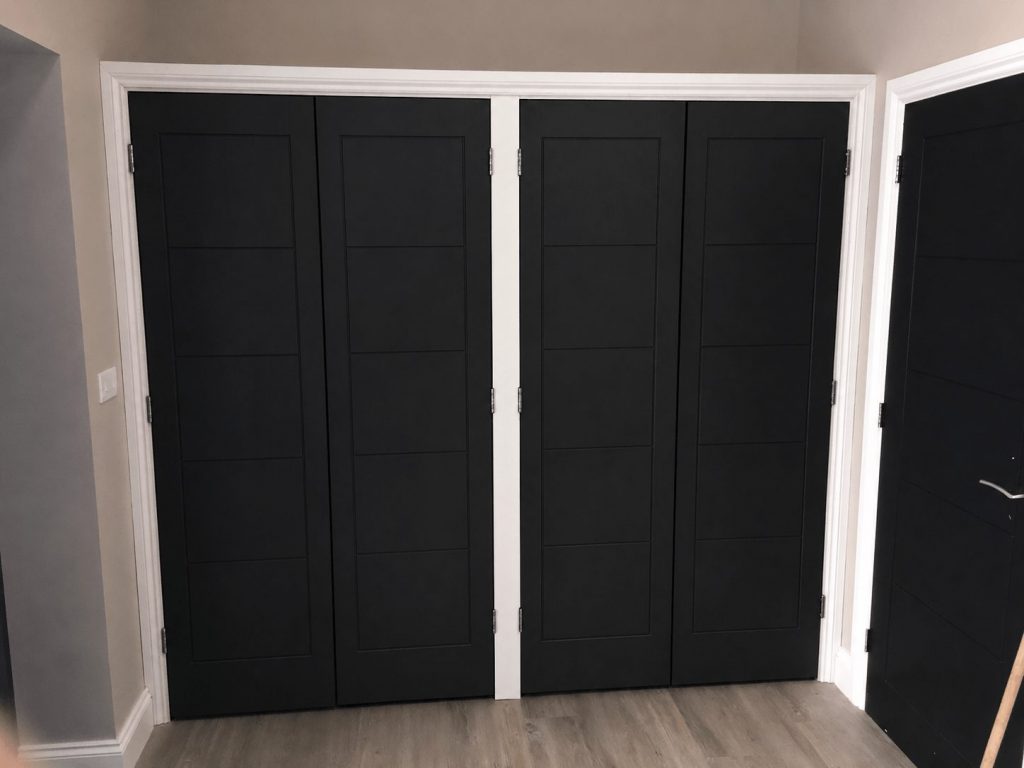 Cloakroom fitted storage with built-in cupboards for shoes and coats.