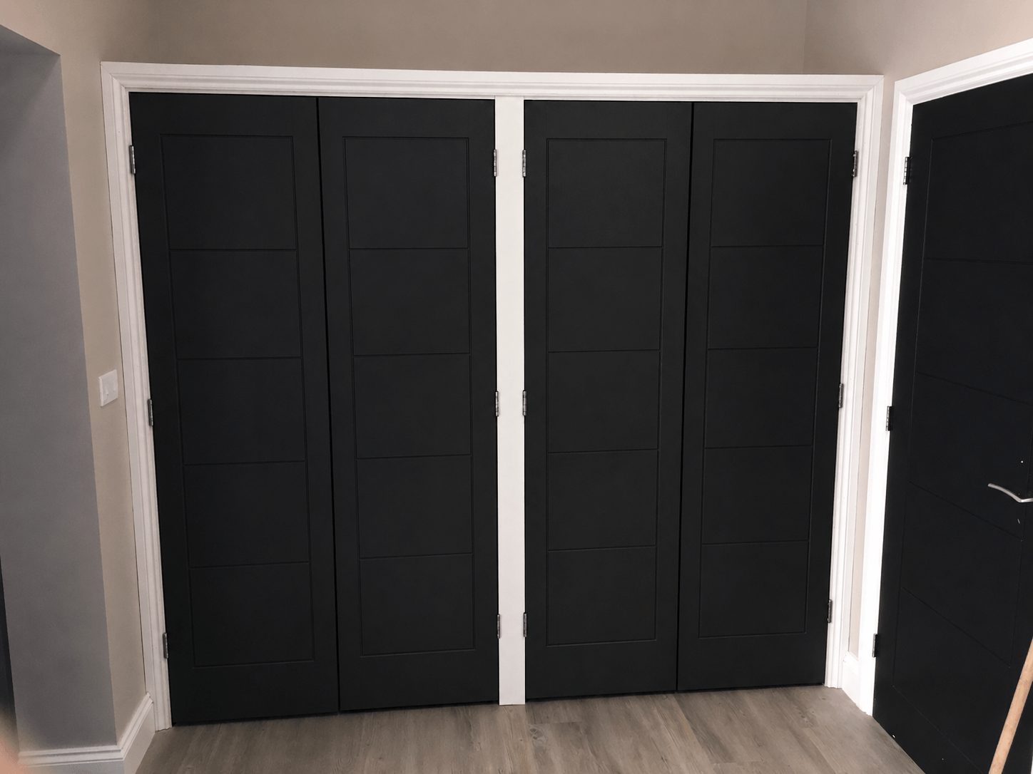 Cloakroom fitted storage with built-in cupboards for shoes and coats.