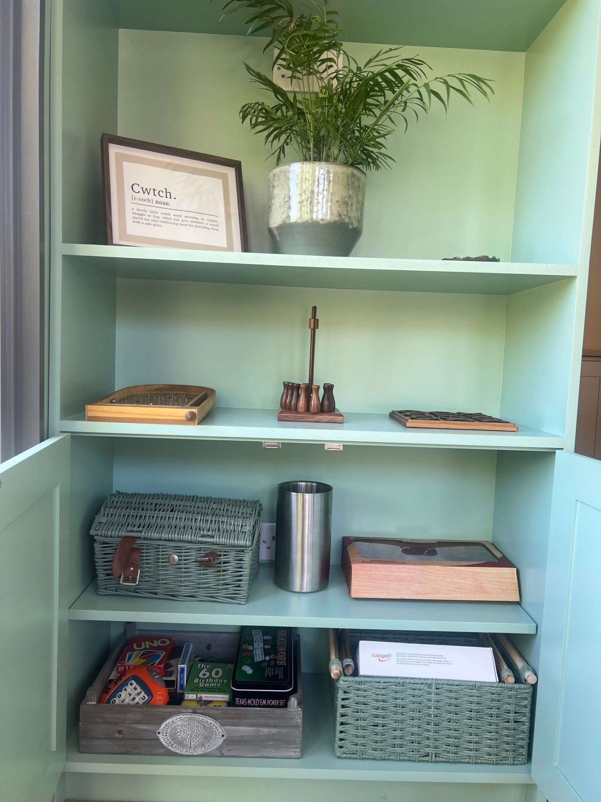 Close-up of fitted shelving with storage baskets and display items.
