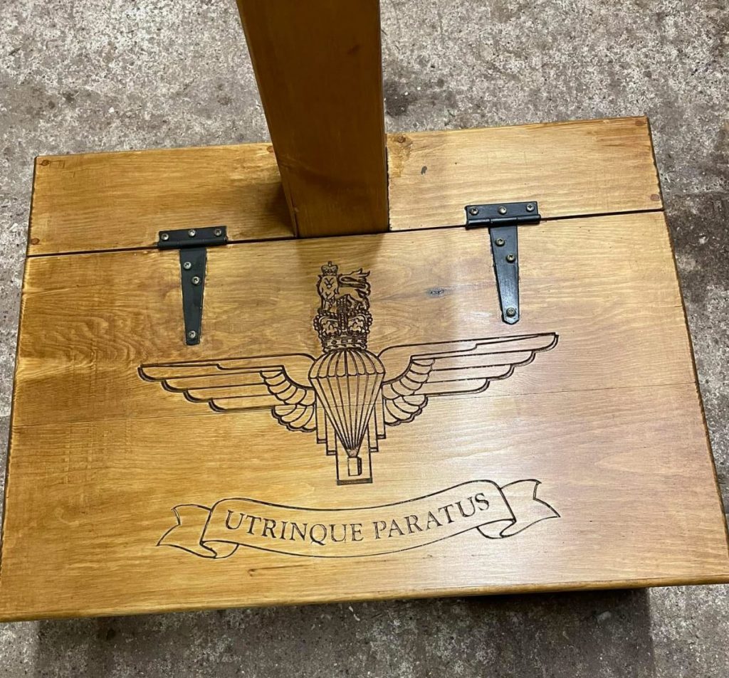 Custom CNC engraved oak armour stand panel featuring detailed military insignia and lettering.