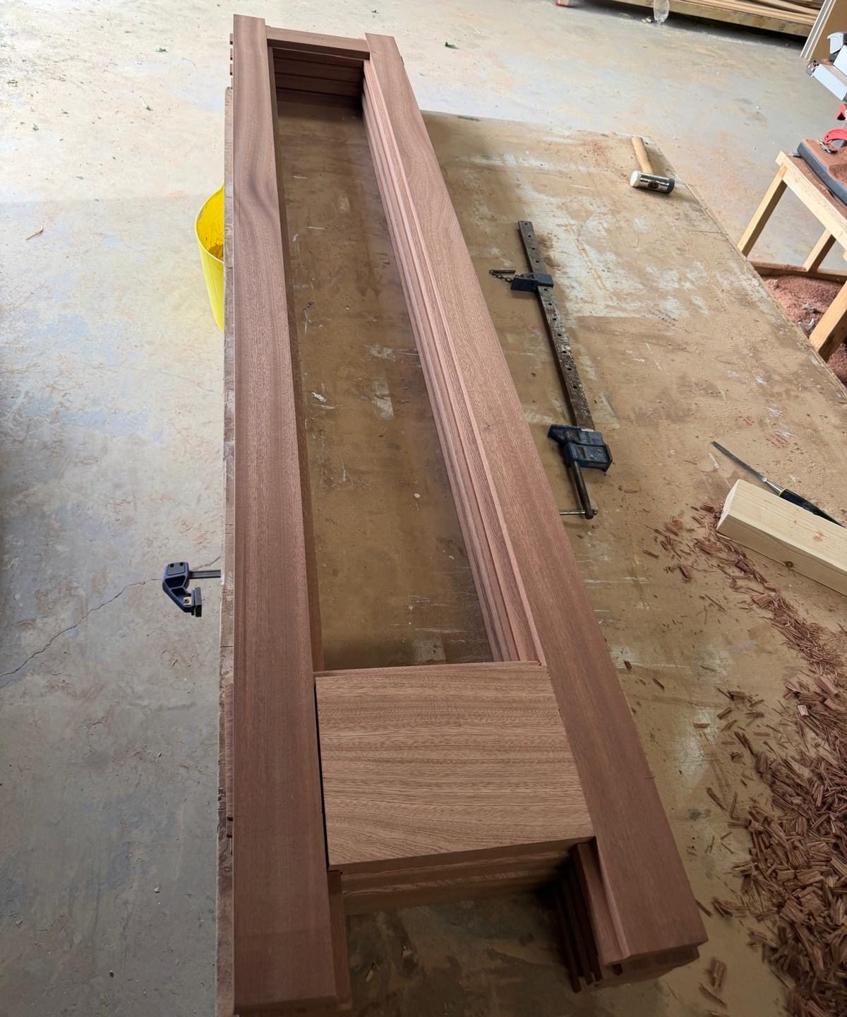 Close-up of traditional mortise and tenon joinery on a solid sapele bi-fold door panel.