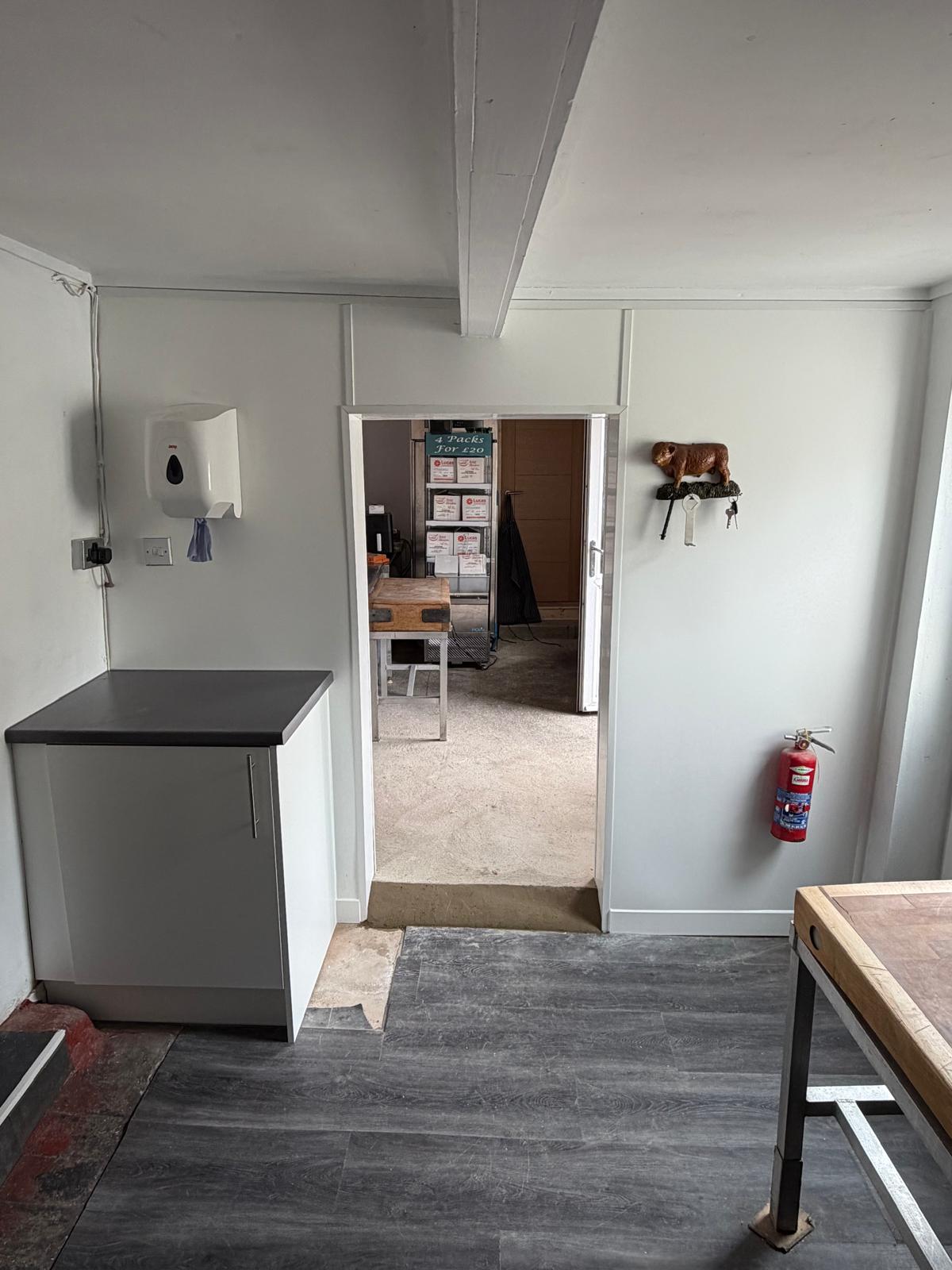 New doorway, hygiene wall cladding and fitted storage completed during a commercial butchers fit-out in March, Cambridgeshire.