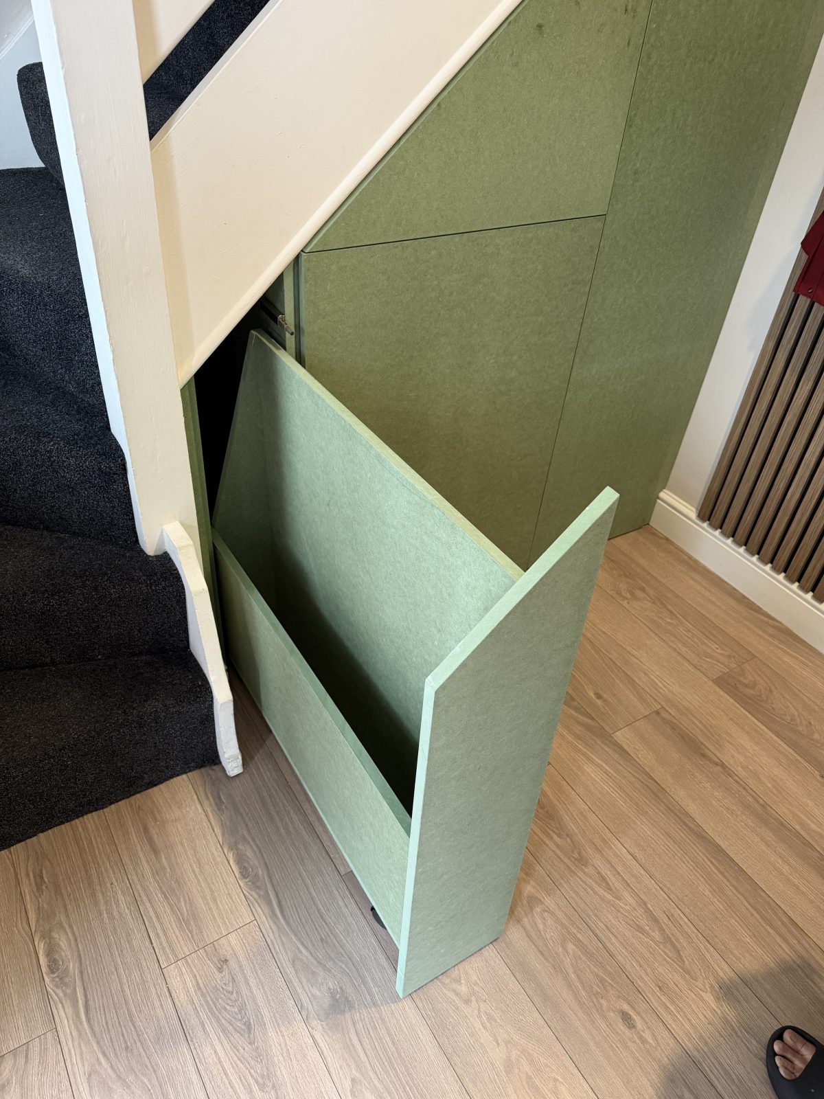 Built-in under stairs storage drawer with push-to-open design in Cambridgeshire.