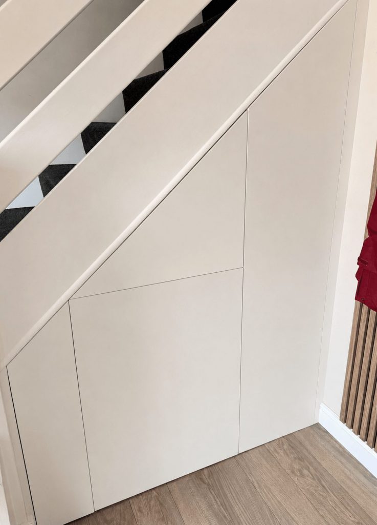 Fitted understairs storage with handleless cupboard doors Cambridgeshire.