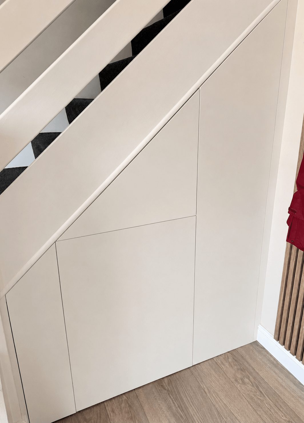 Fitted understairs storage with handleless cupboard doors Cambridgeshire.